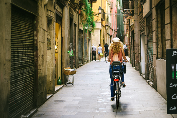 girl bicycling in barcelona streets